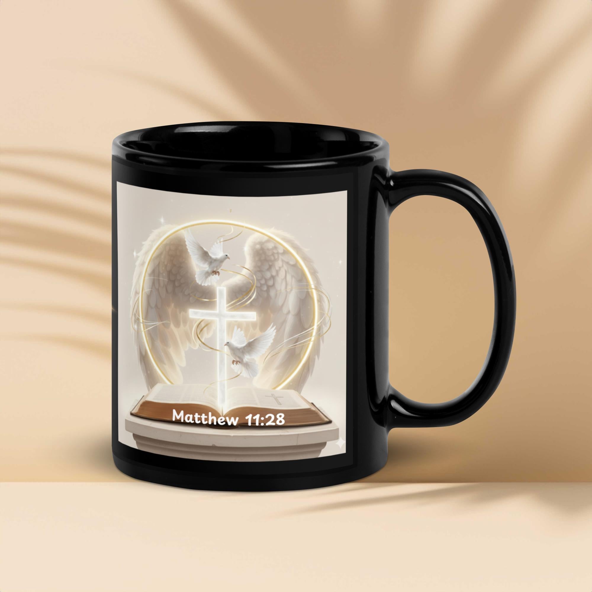 Black mug with a religious design and 'Matthew 11:28' text on a beige background