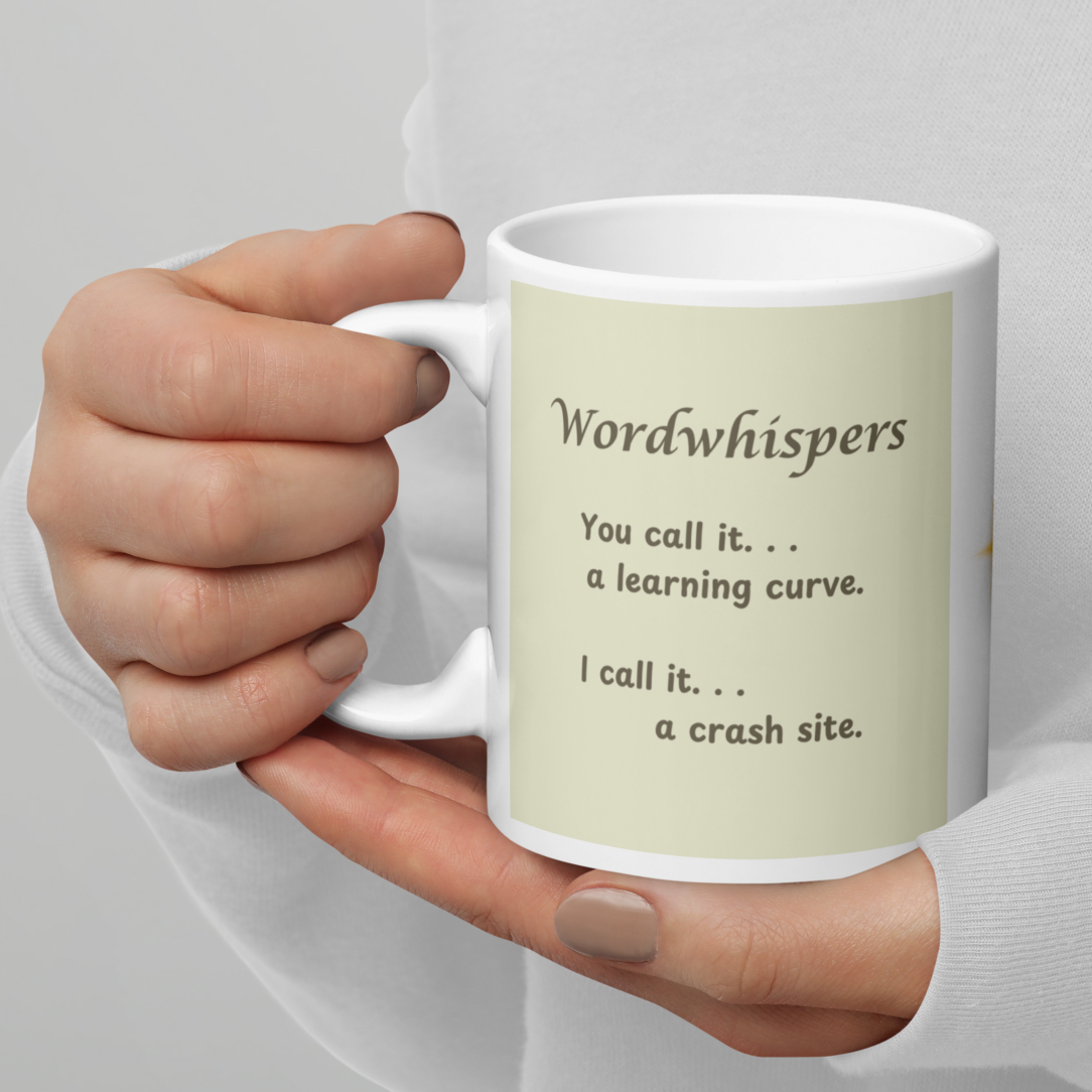 White ceramic mug with rainbow-colored "You call it a learning curve, I call it a crash site" quote text — Wordwhispers creative gift for writers